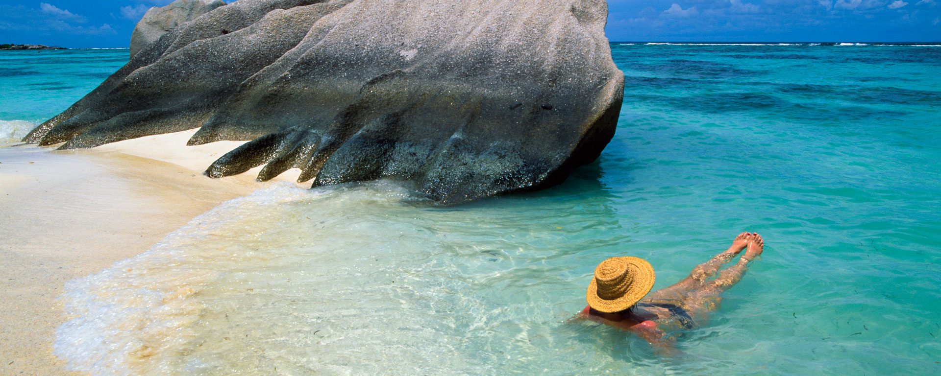 Woman swimming at beach on La Digue Island, Seychelles